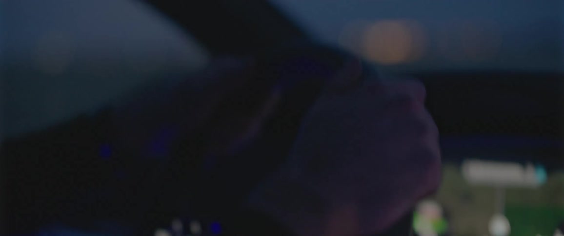 Mans hands holds steering wheel to control the direction that the vehicle goes in