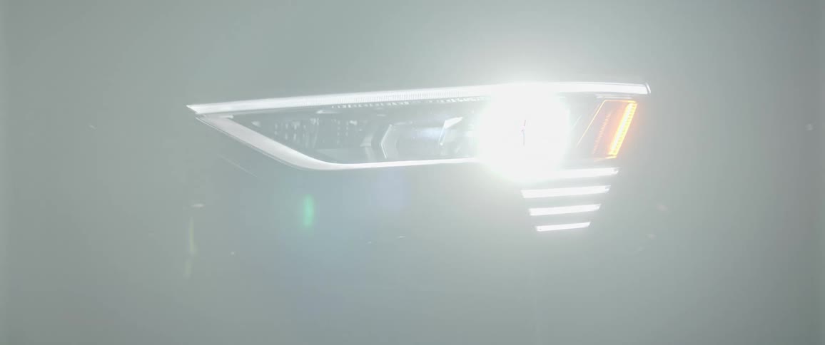A close up of a car turning on headlights