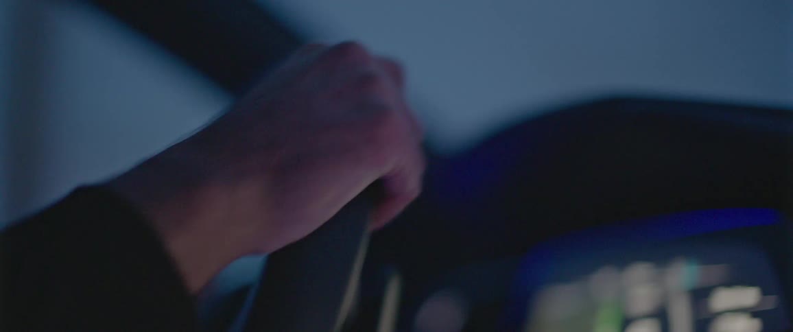 A man is driving a vehicle with two hands