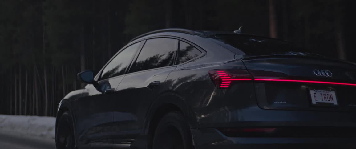 A car driving down the road on a winter day