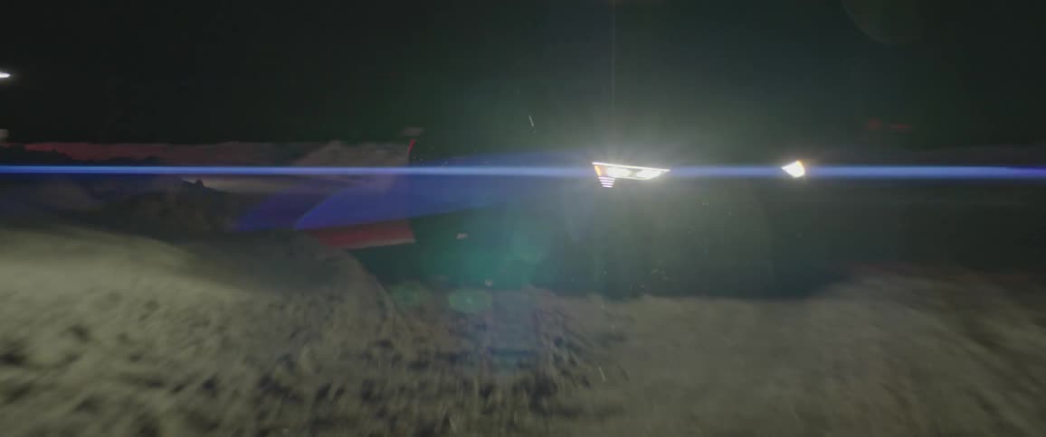 A car drives away from a building in a rural area