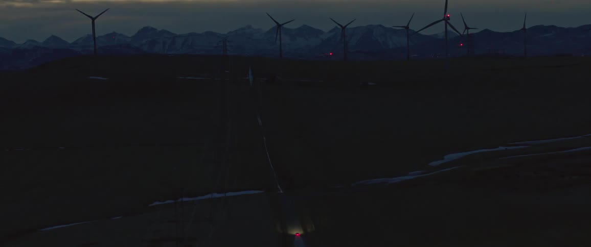 A view of windmills from the sky at night
