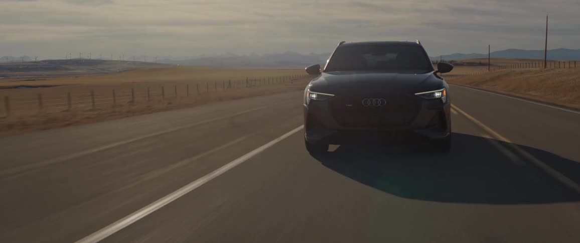 A vehicle drives a rural road