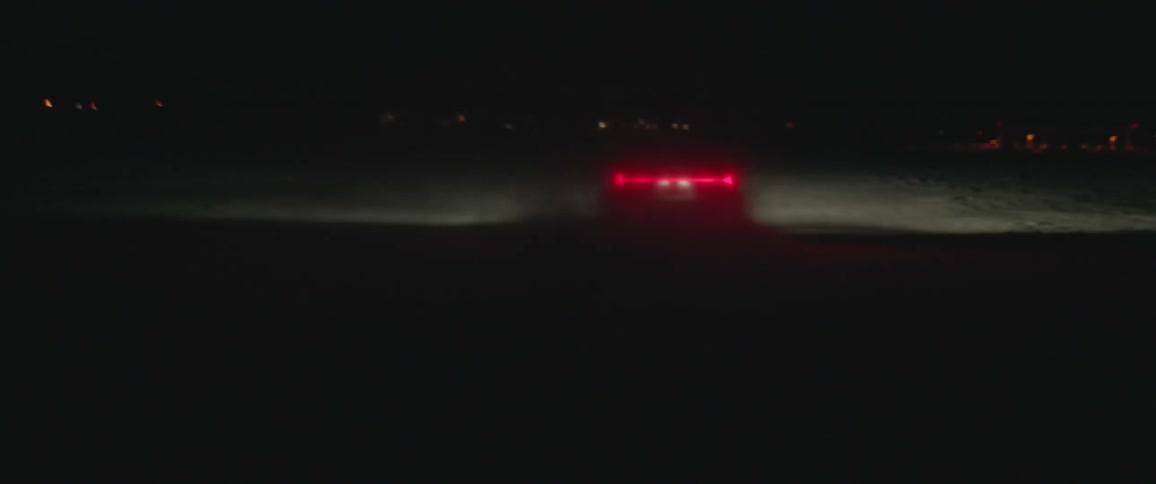 A vehicle driving on a snowy field
