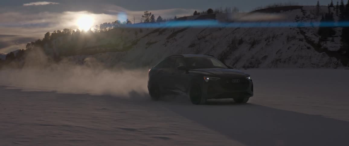A car is driving off road in winter at dusk