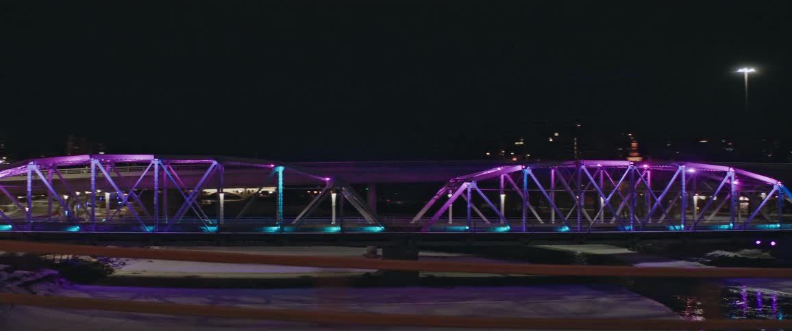A view of a bridge over a river at night