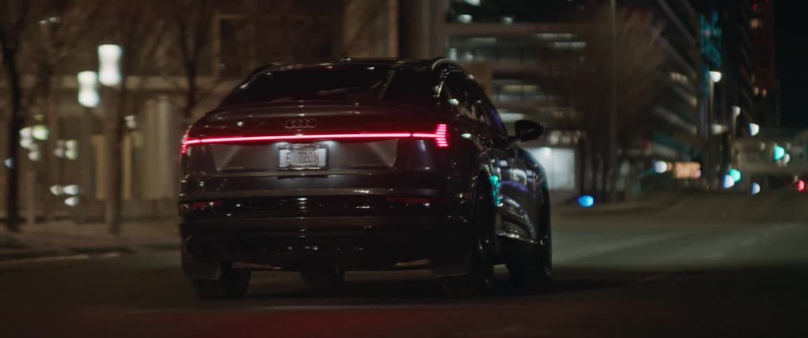 A car driving in a city at night