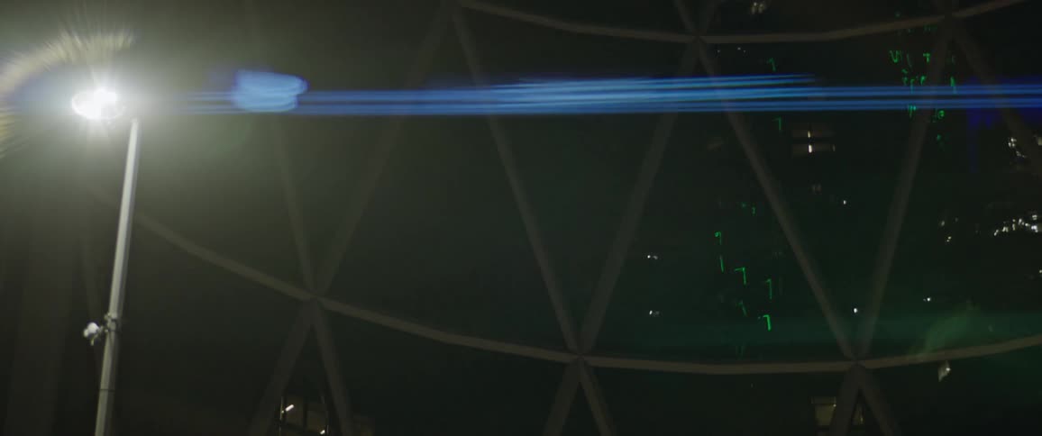 Sculpture in the plaza of a building in the city at night