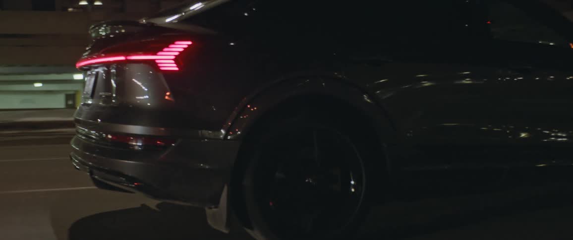 A car is driving down the city road