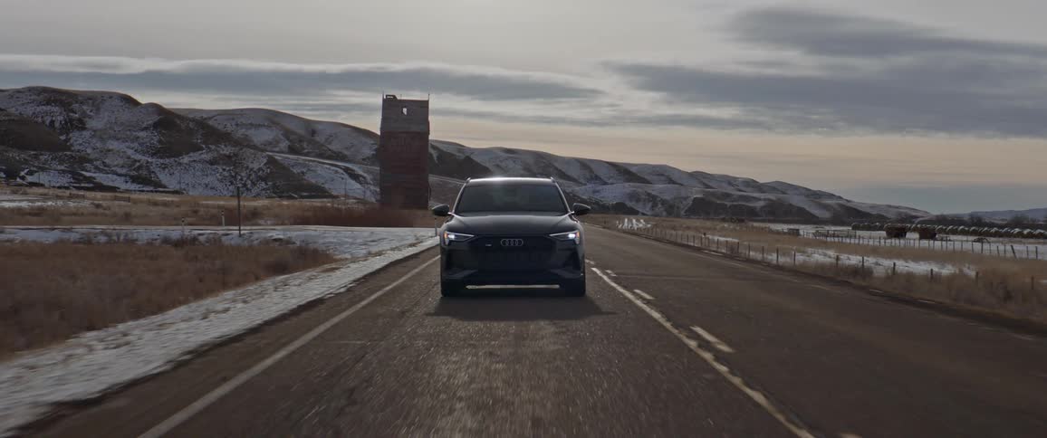 A car driving down a road during the winter