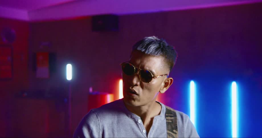 Hip hop dancer rehearsing in a studio filled with neon lights