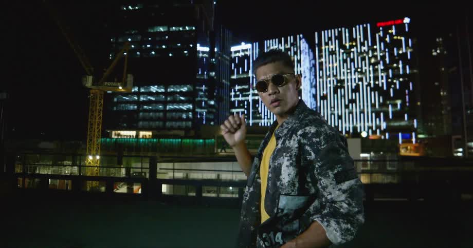 A man dancing outdoors at night