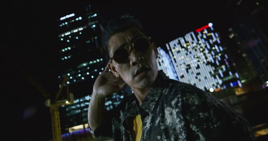 Dancer wearing sunglasses makes some hand gestures