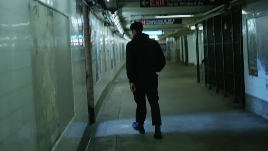 A man is walking out of a metro train station