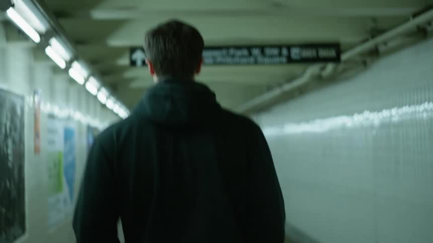 Young man walking down the corridor of a subway station