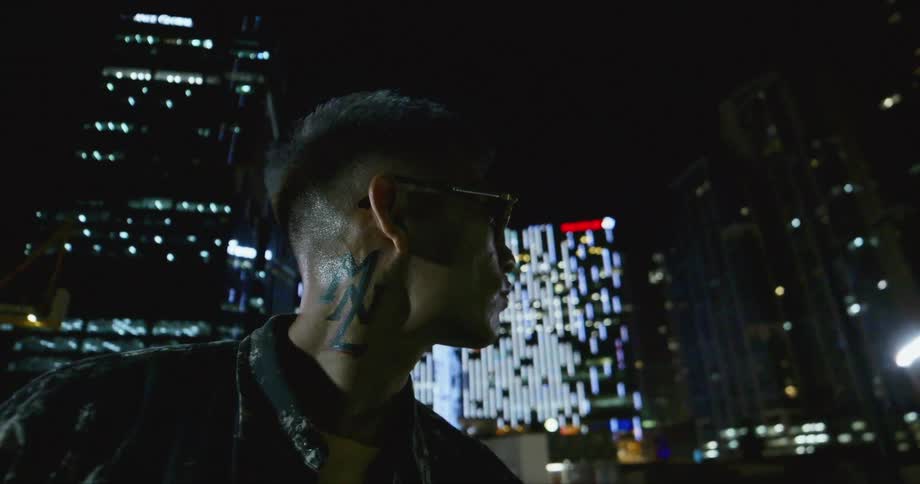 Dancer staring afar with the city lights and skyline in background