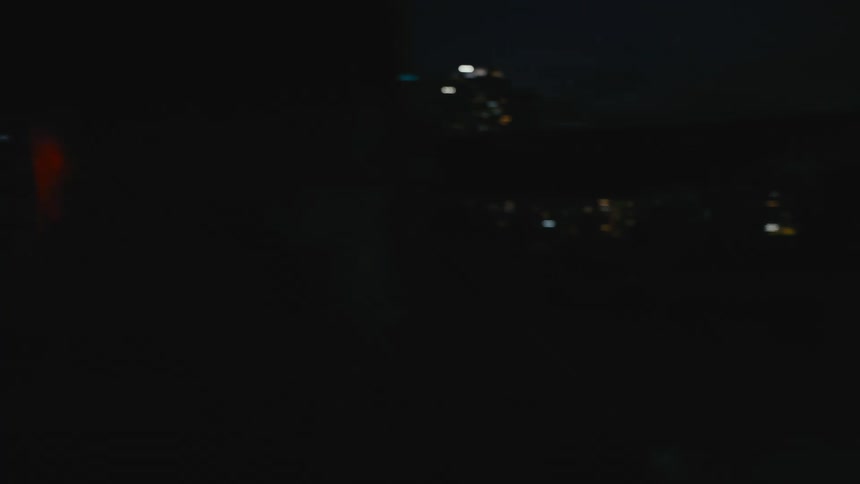 Strong muscular shirtless asian man screaming violently near the city at night