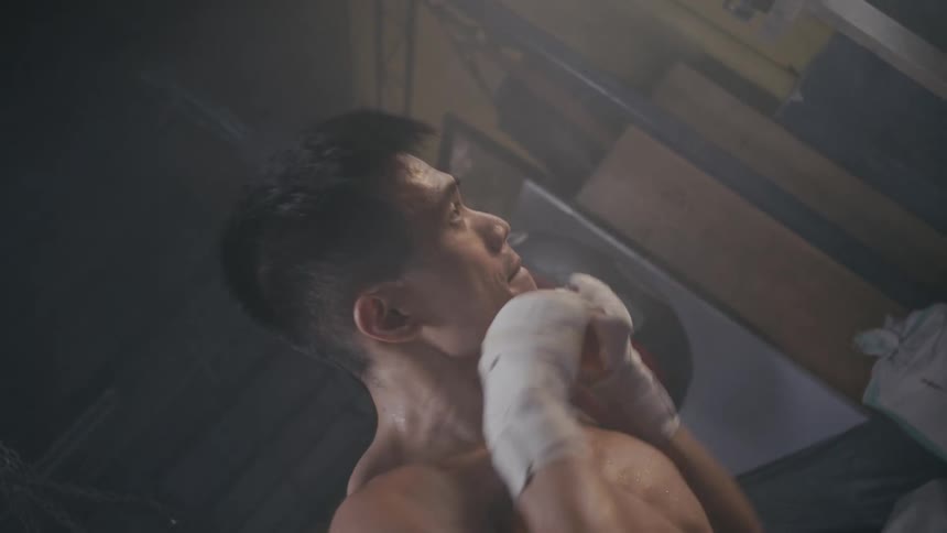A man throws boxing punches indoors