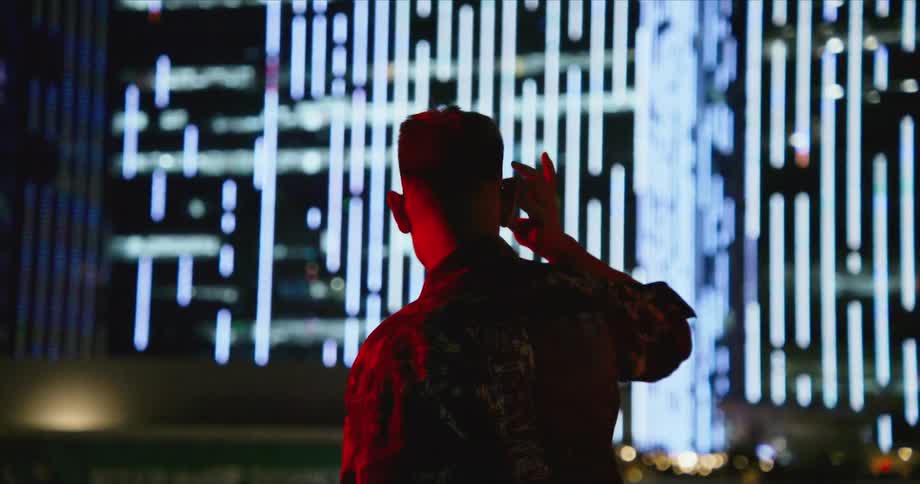 A man is looking at a large display