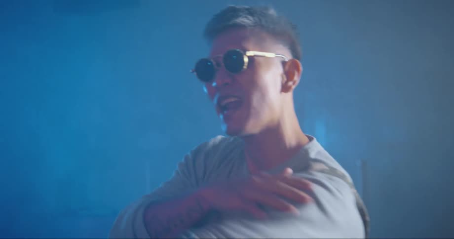 A man dancing in a room while singing