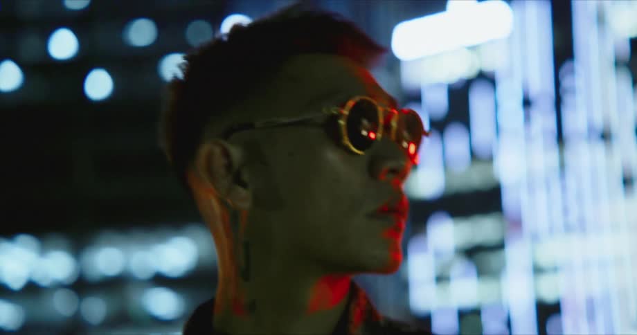 An asian male is wearing sunglasses and looking at things around him