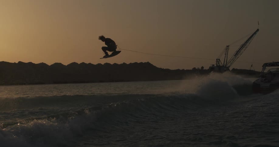 A man riding on a board over waves in the ocean