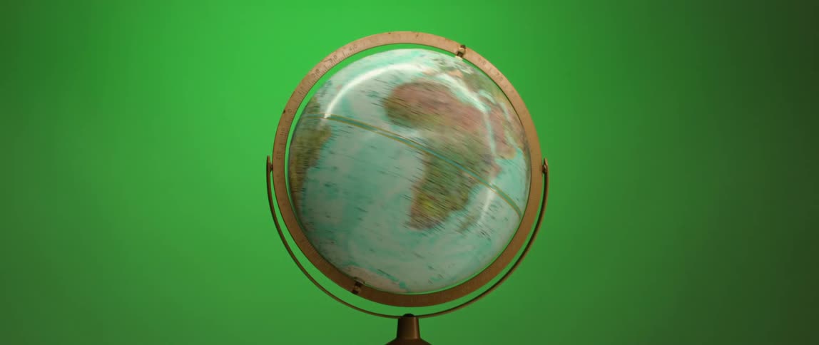 A world globe is spinning in front of colors