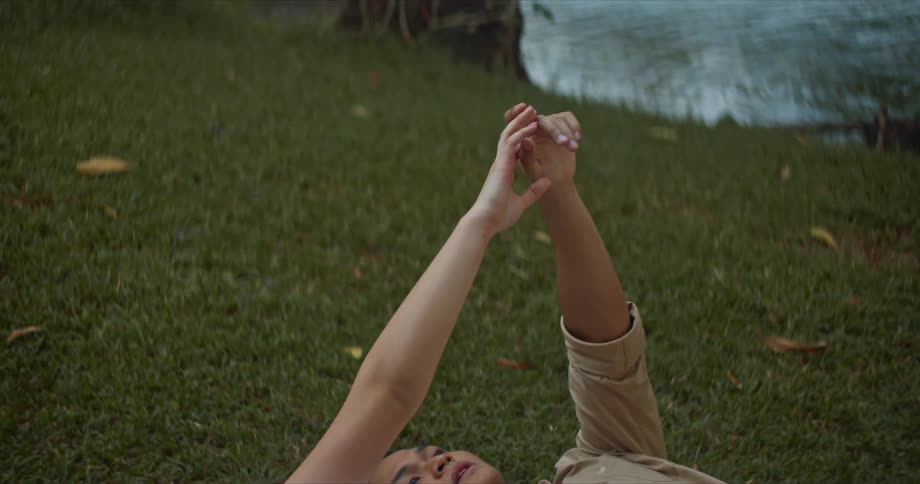 A man and woman laying on the grass together