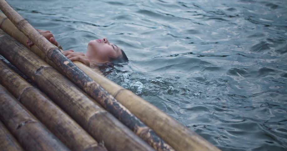 Two people swimming in a lake