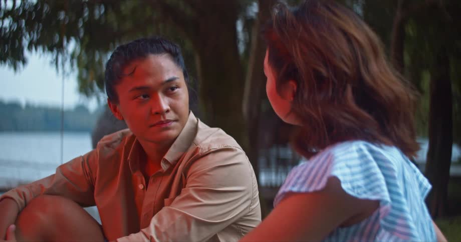 Two people sitting outside talking