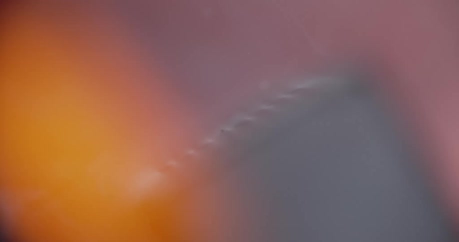 Close up of matchstick rubbing against the red strip on the side of the matchbox