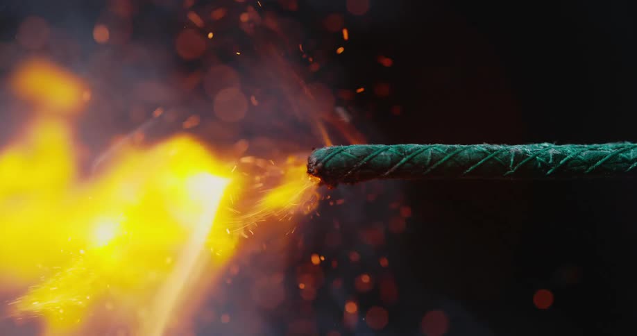 Close up of a match lighting a firework