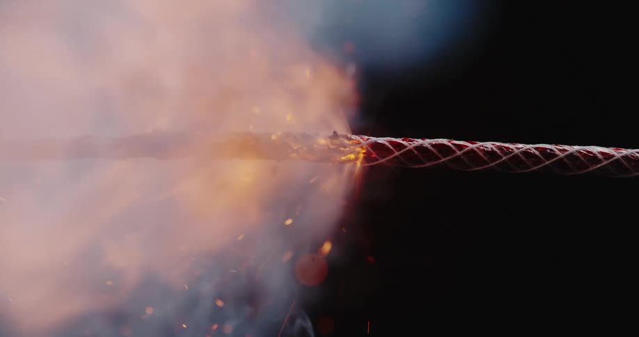 A sparking flame quickly works its way along a braided fuse wire