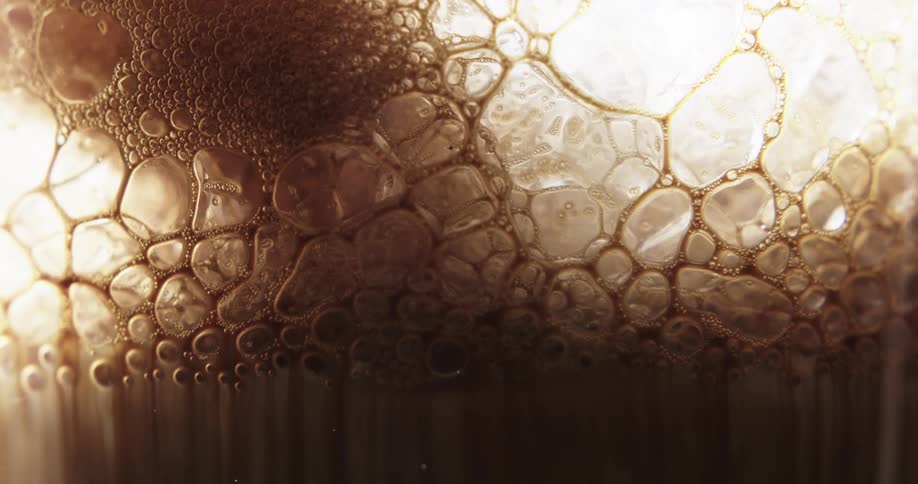 Brown bubbles in liquid popping and moving