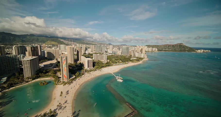 An aerial view of the high rise hotels on the beach with the waves rippling in the water