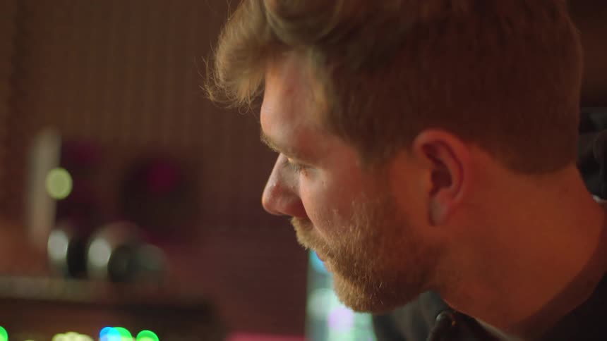 Musician playing an electric guitar inside a studio
