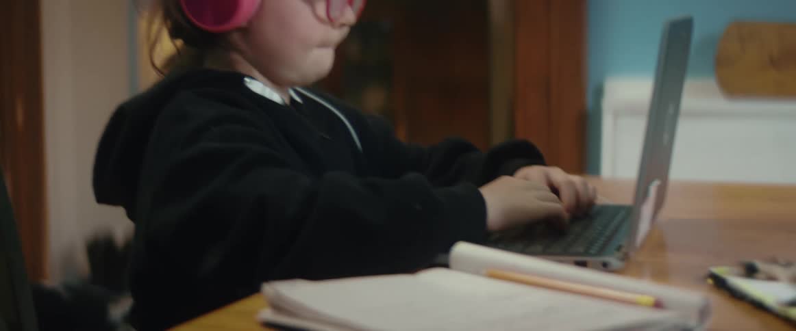 A child working on a laptop
