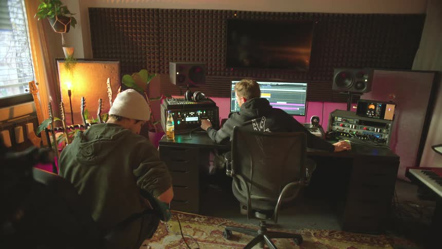 Couple of musician composing and mixing music in a studio
