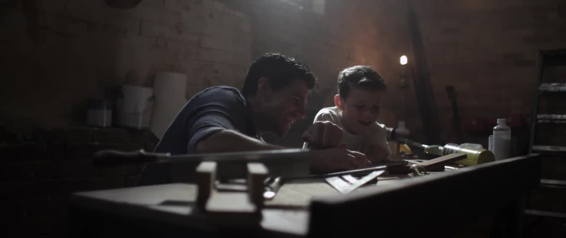 A man and boy work in a shop