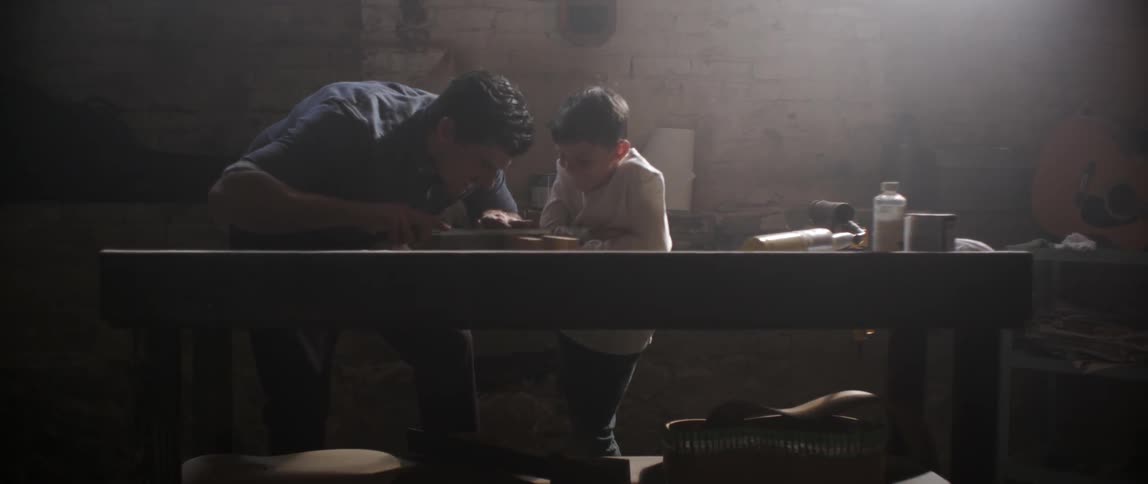 A man and child work together on a project