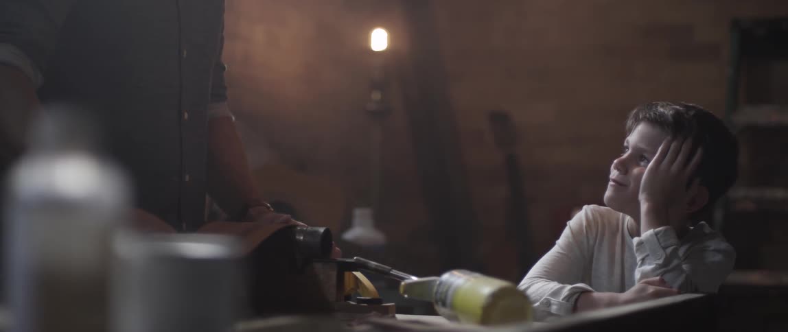 A child watches as a man works