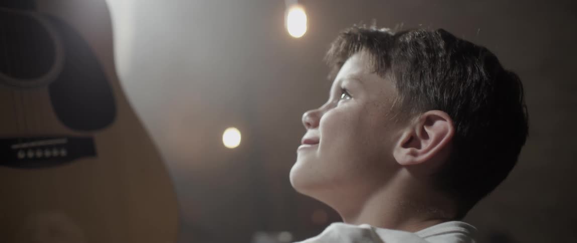 A boy looks up and smiles
