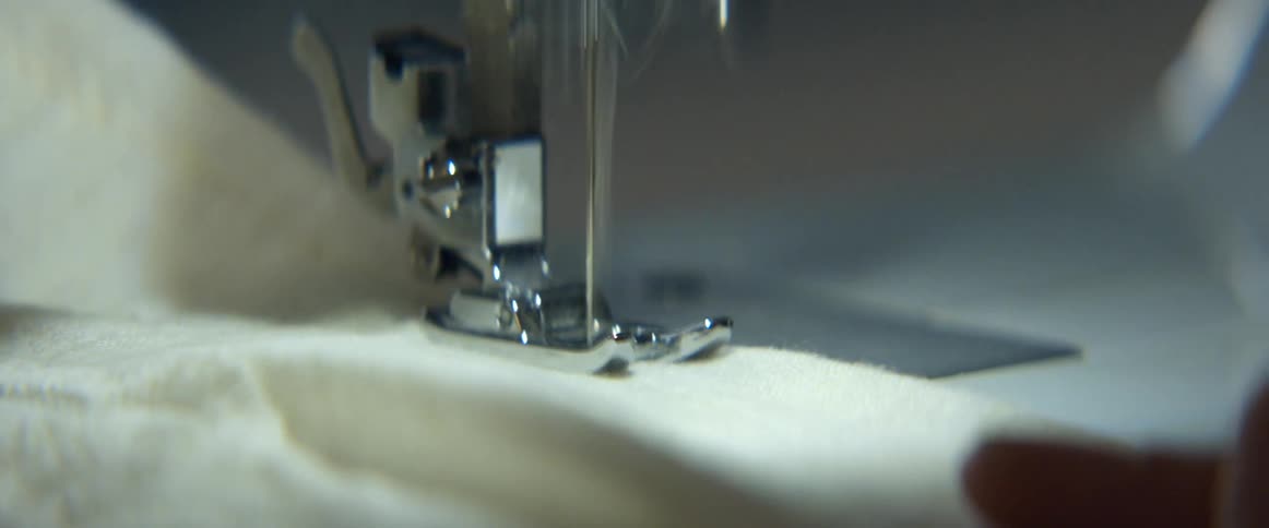Fabric is being sewn on a sewing machine