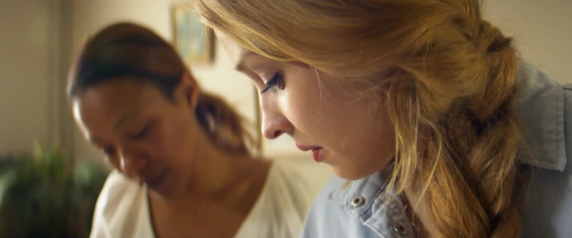 Two women talking together in a room