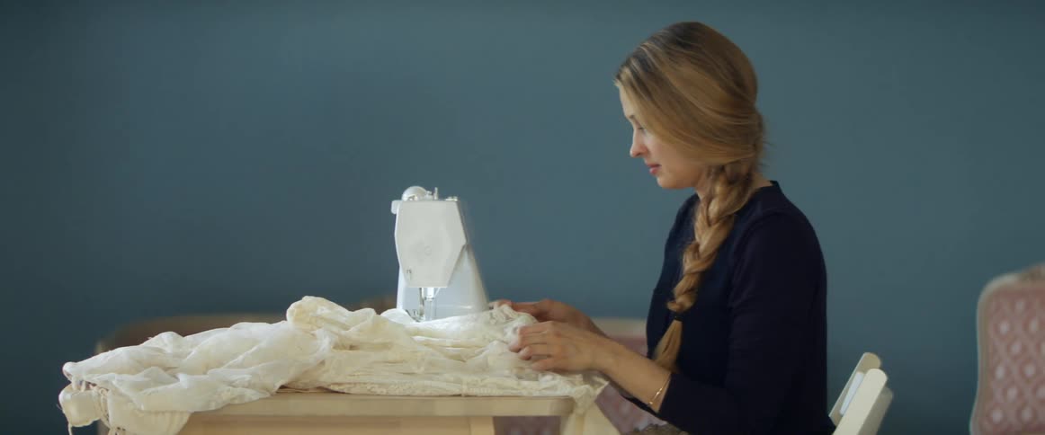 A woman is using a sewing machine