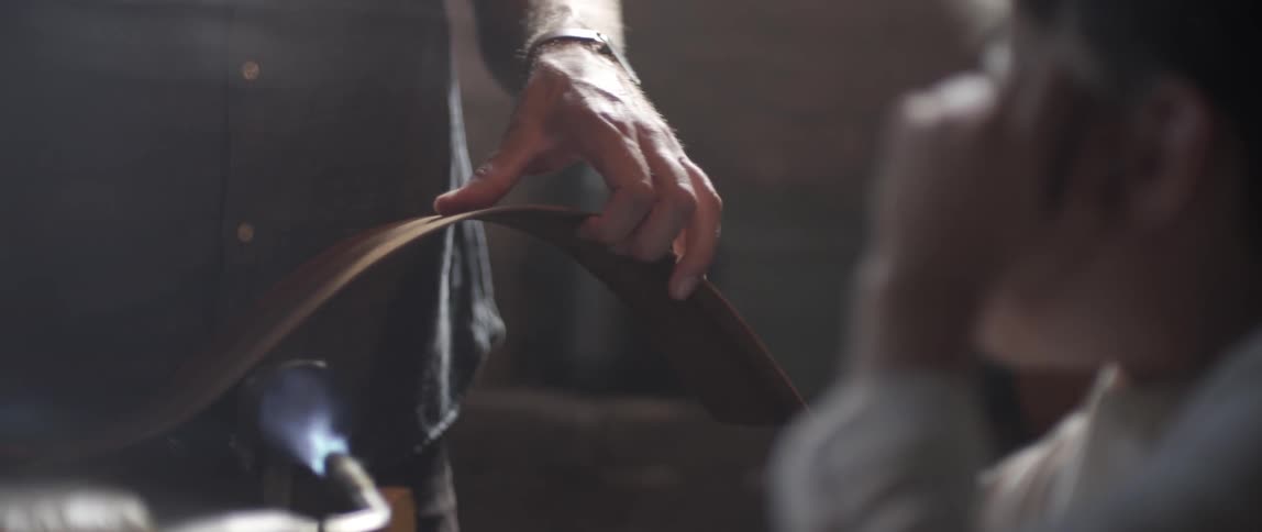 A man is using a torch to form something