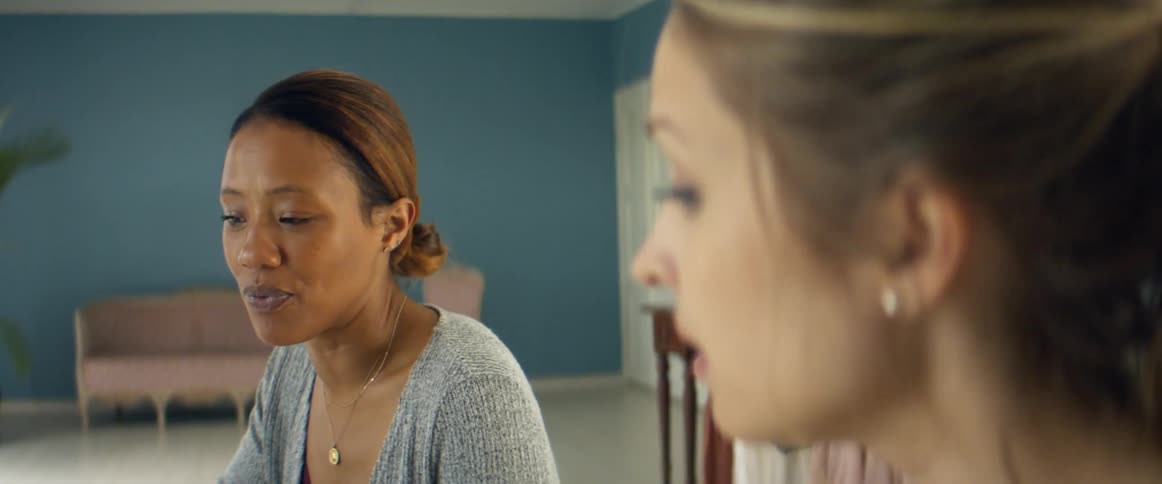 Clothes designer talking to a client in her studio