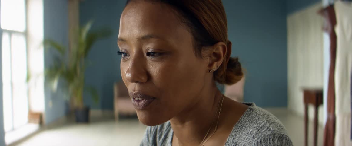 A woman is talking and nodding her head