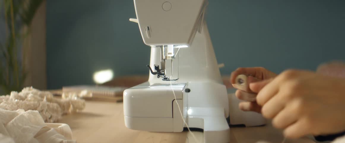 A woman preparing a sewing machine