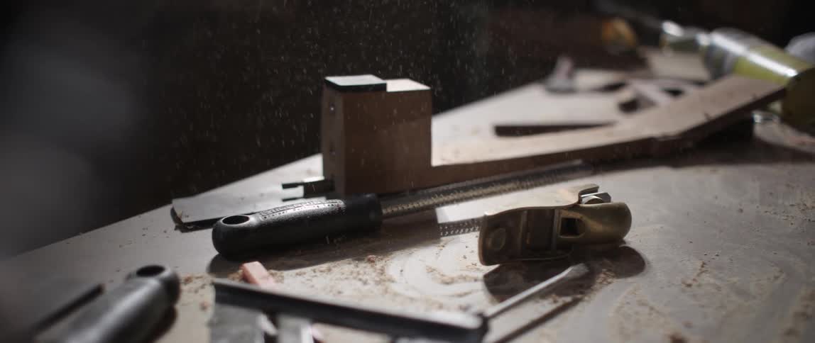 Wood shavings hit a tool covered table